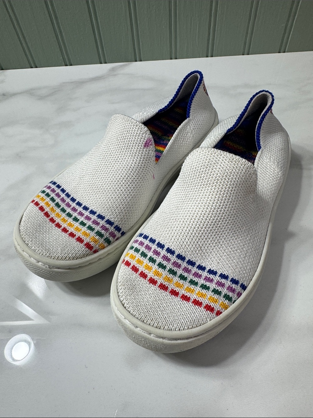 Rothy's White Knit Slip-On Sneakers with Rainbow Stripe